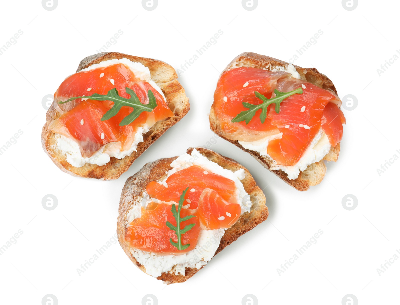 Photo of Delicious sandwiches with cream cheese, salmon and arugula on white background, top view