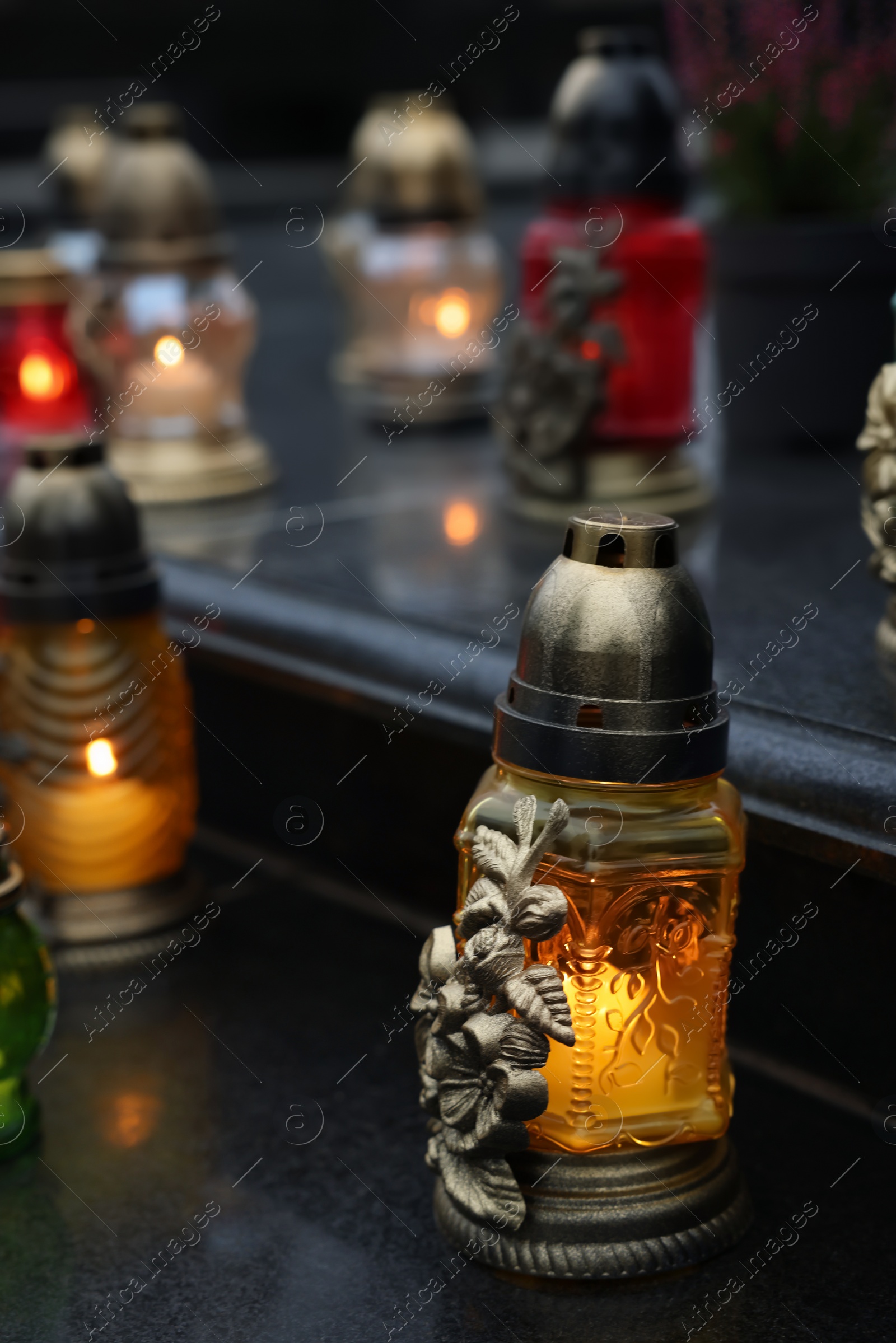 Photo of Grave lights on granite surface at cemetery