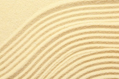 Zen rock garden. Wave pattern on beige sand, top view