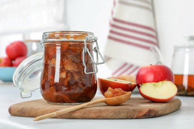 Delicious apple jam and fresh fruits on white table