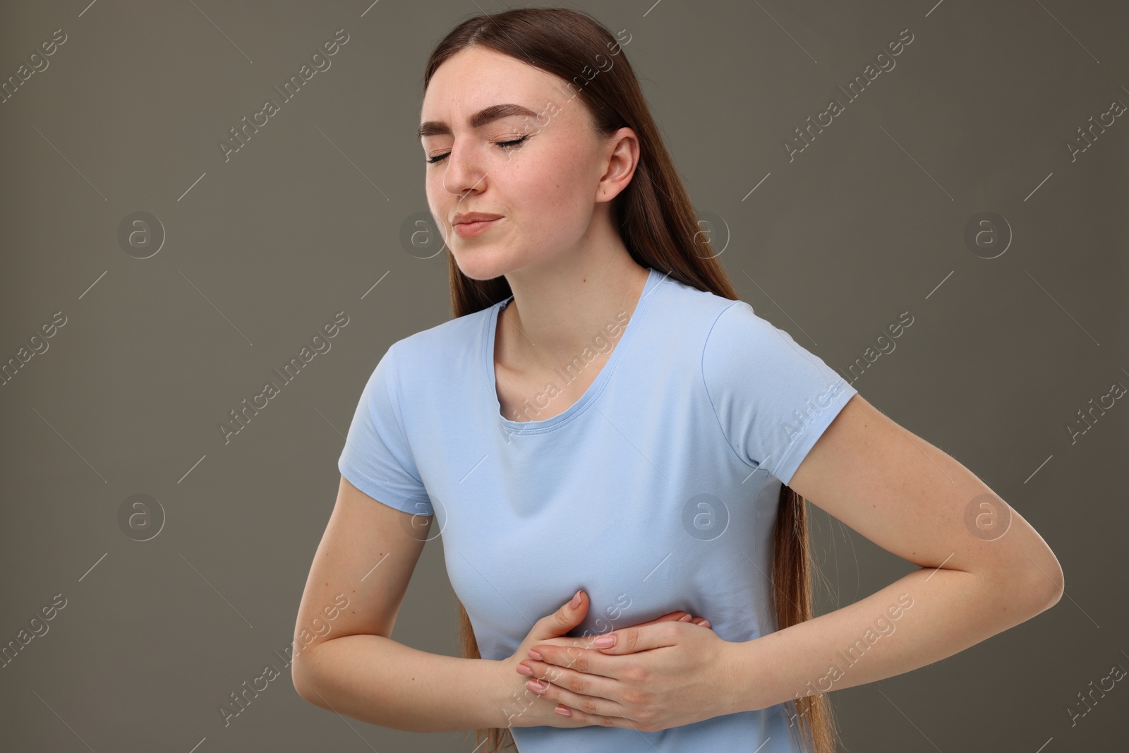 Photo of Woman having heart attack on grey background