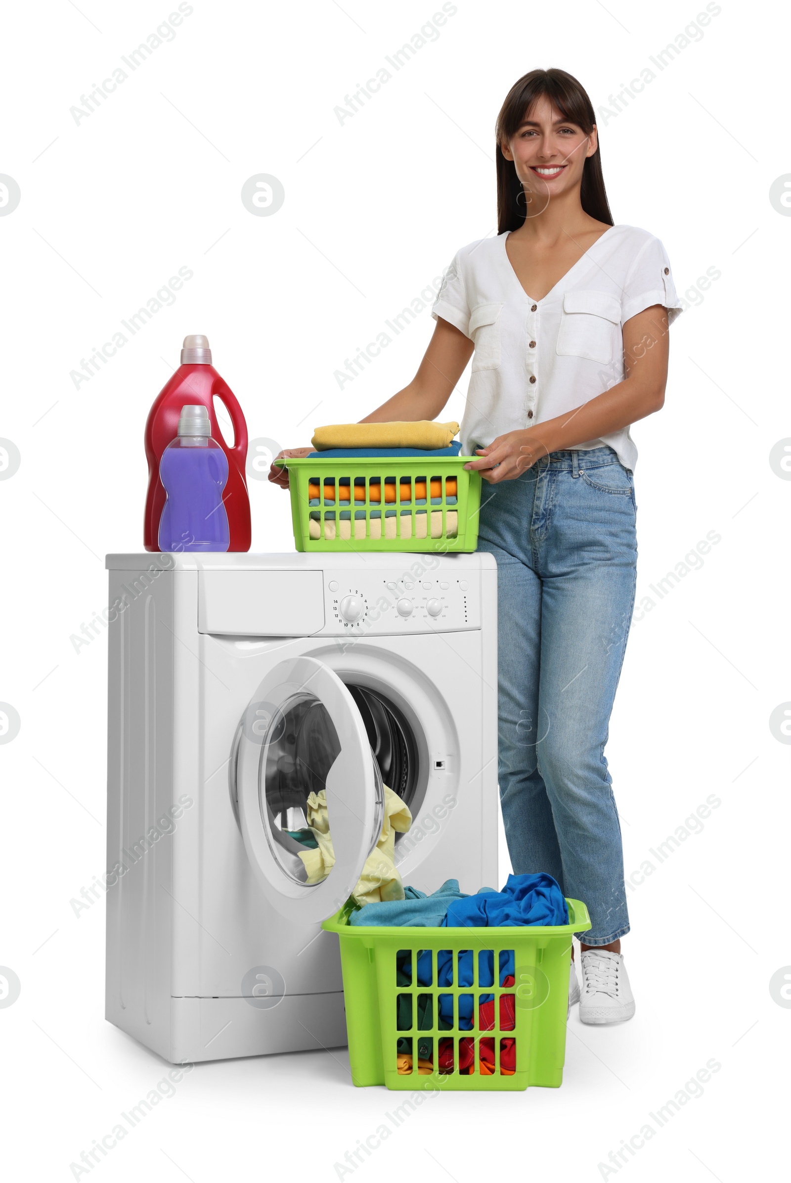 Photo of Beautiful woman with laundry basket near washing machine on white background