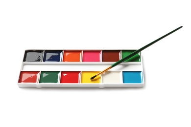 Photo of Plastic watercolor palette with brush on white background. Painting equipment for children