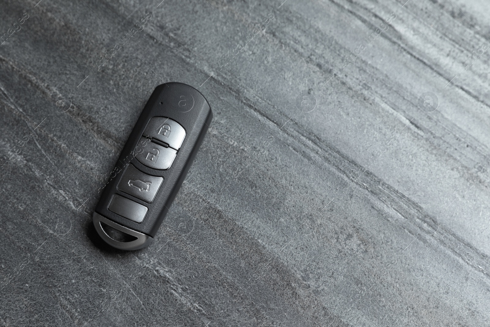 Photo of Car smart key on grey background, top view with space for text