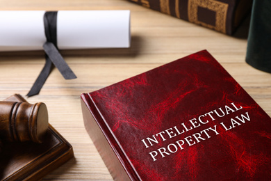 Image of Intellectual Property law book and judge's gavel on wooden table