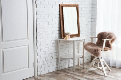 Beautiful mirror on table in modern makeup room