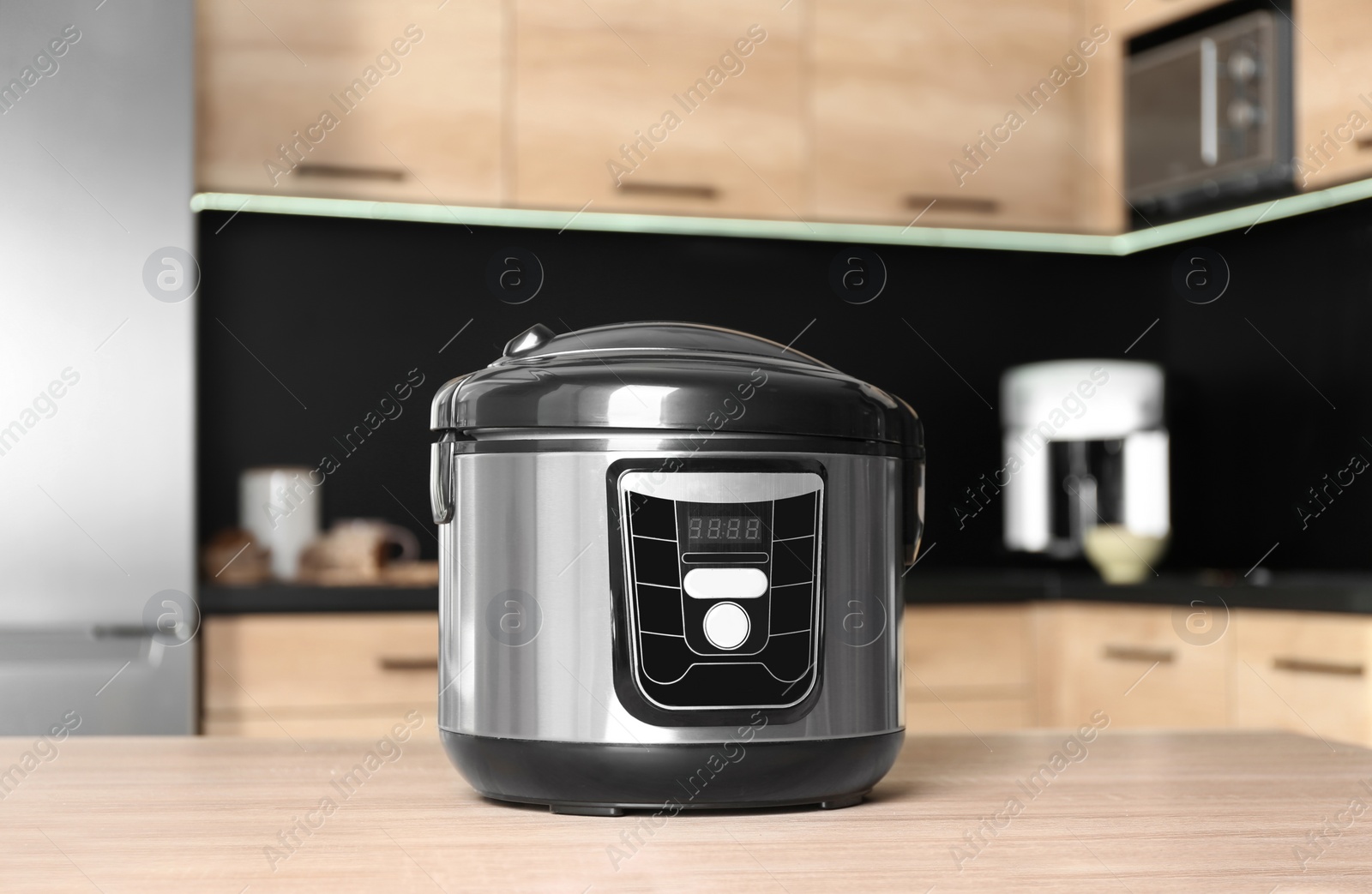 Photo of Modern multi cooker on table in kitchen
