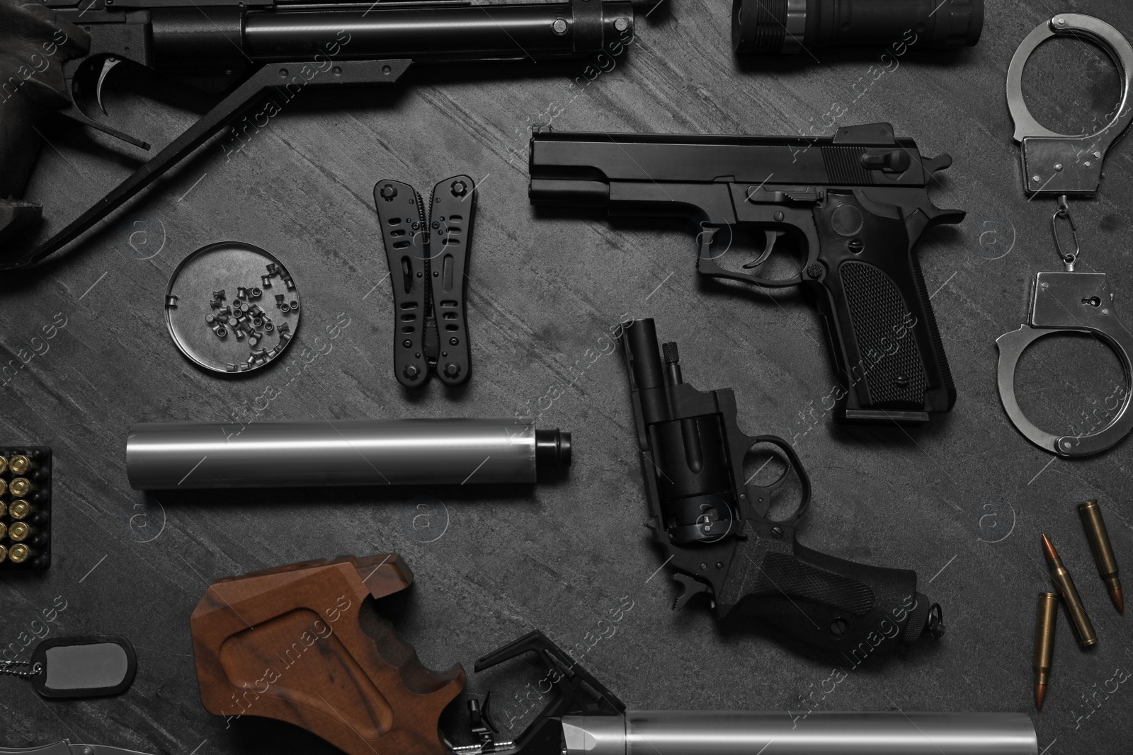 Photo of Flat lay composition with different guns on dark table