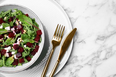 Photo of Delicious beet salad served on white marble table, top view. Space for text