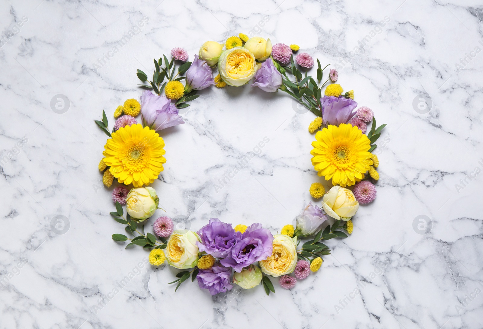 Photo of Wreath made of beautiful flowers and green leaves on white marble background, flat lay. Space for text