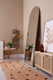 Beautiful mirror and console table near beige indoors. Interior design