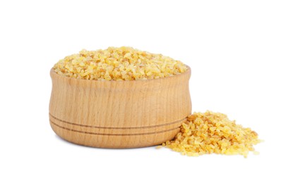 Wooden bowl with uncooked bulgur on white background