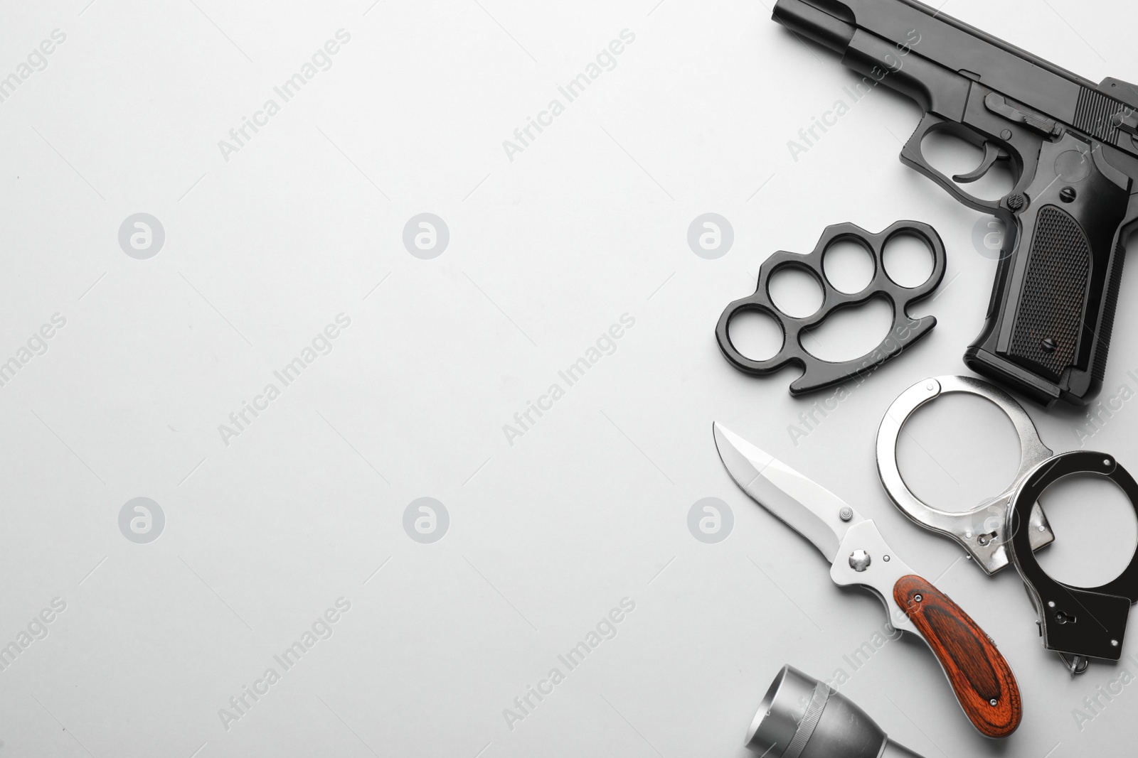 Photo of Flat lay composition with black brass knuckles on white background Space for text