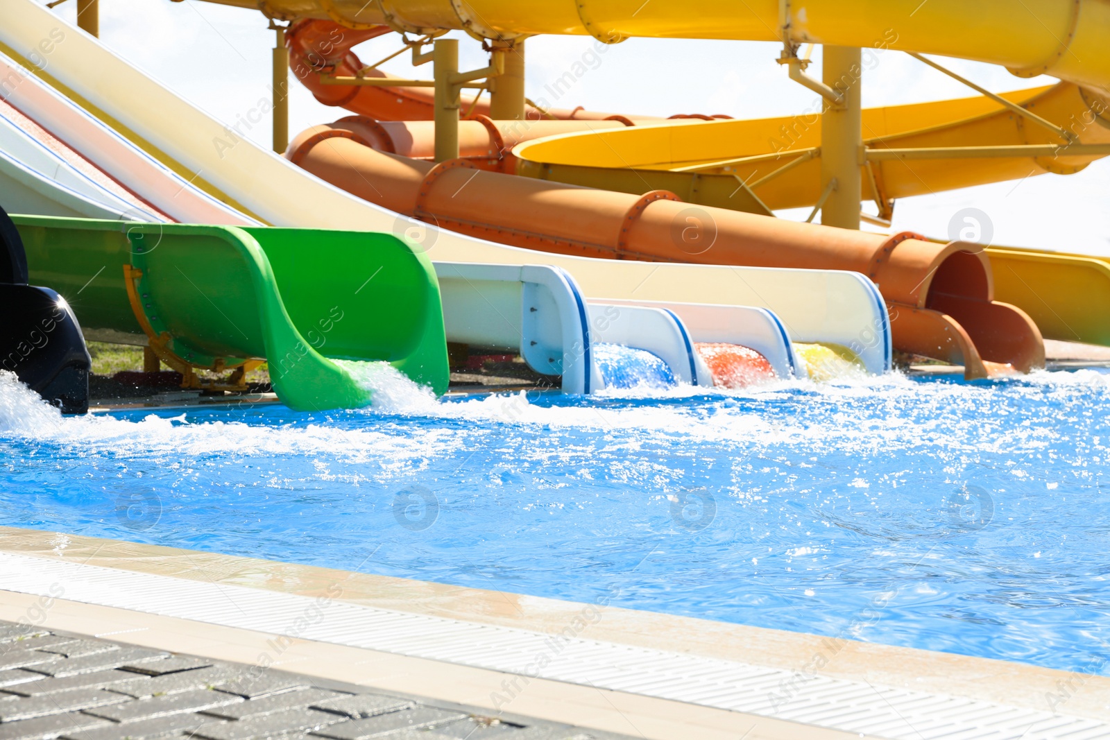 Photo of Different colorful slides in water park on sunny day