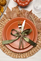 Photo of Beautiful place setting with autumn decor on white wooden table, flat lay