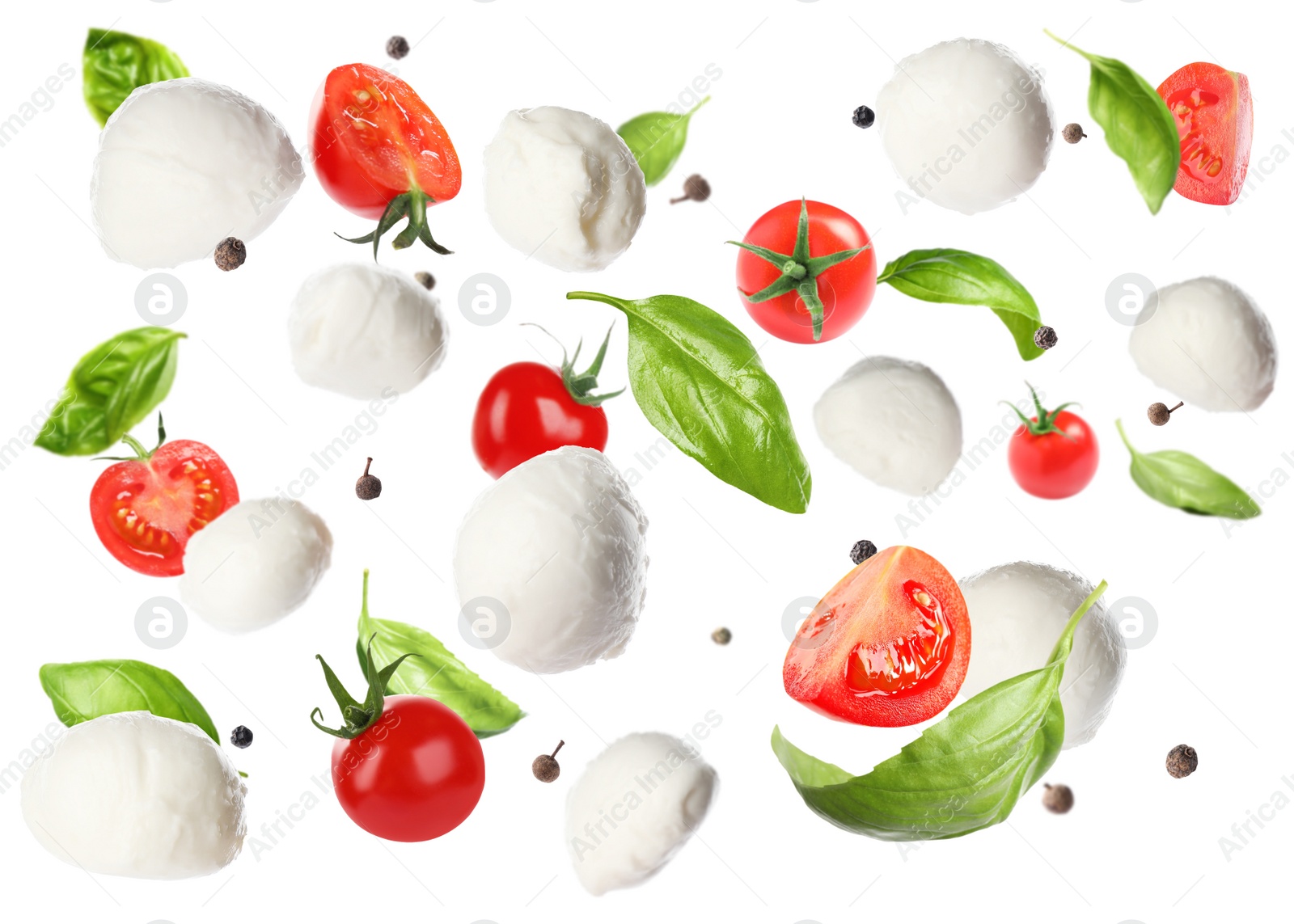 Image of Mozzarella cheese balls, tomatoes, basil leaves and peppercorns for caprese salad flying on white background