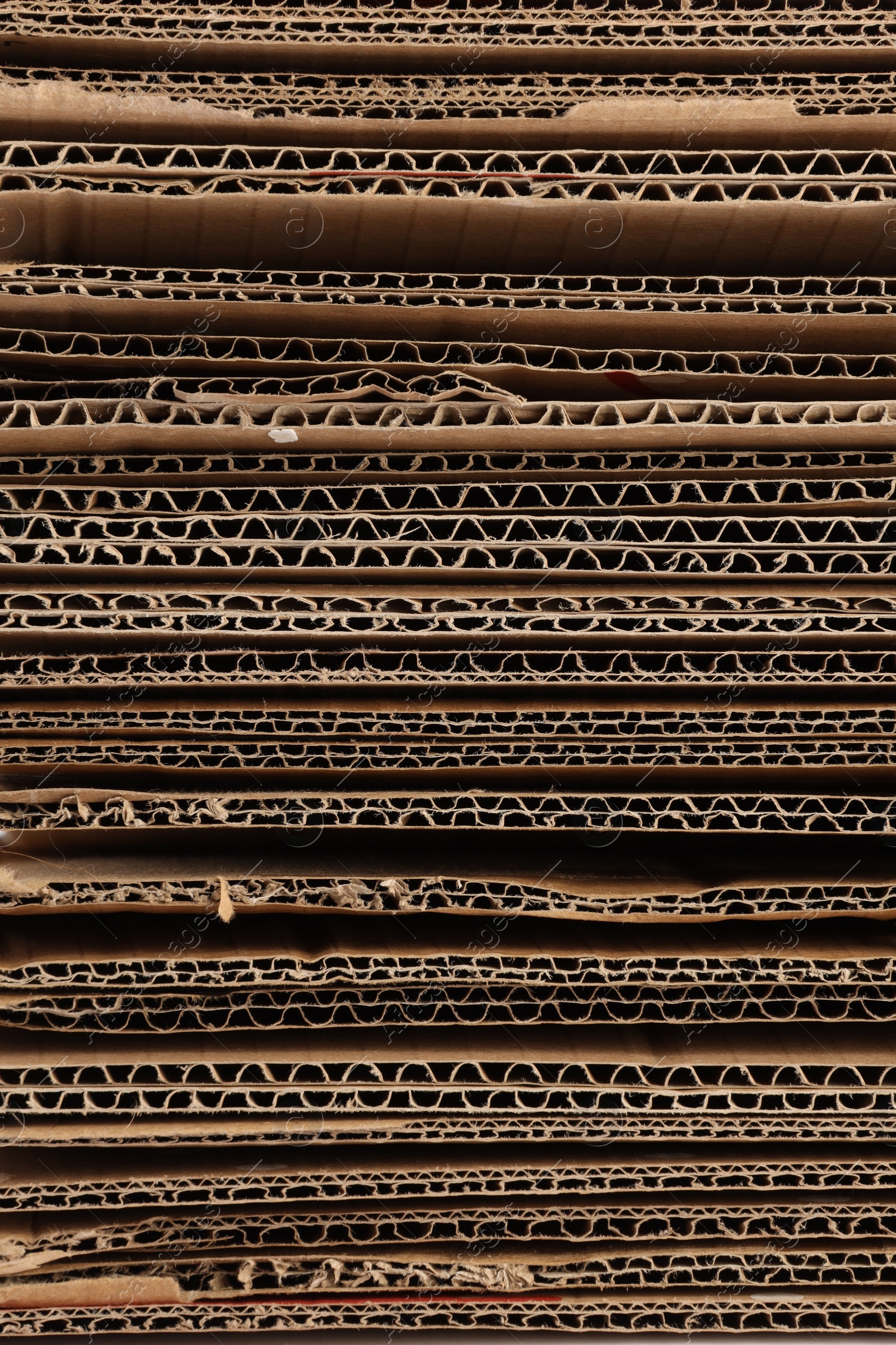 Photo of Sheets of brown corrugated cardboard as background, closeup