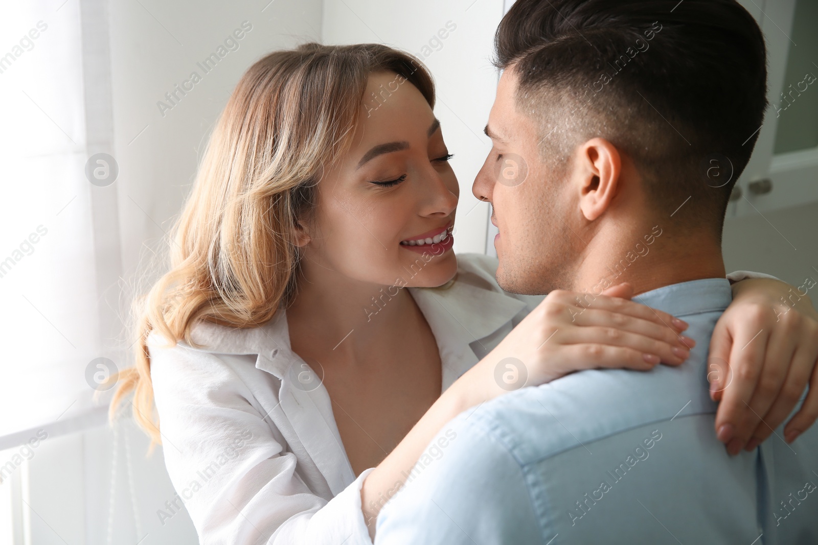 Photo of Lovely couple enjoying time together in kitchen at home