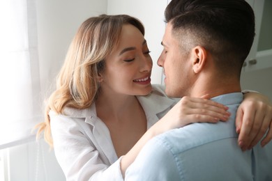 Lovely couple enjoying time together in kitchen at home