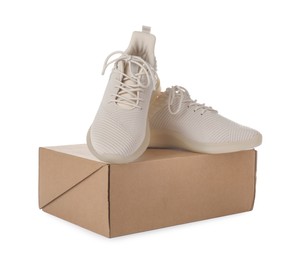Photo of Pair of stylish sport shoes and box on white background