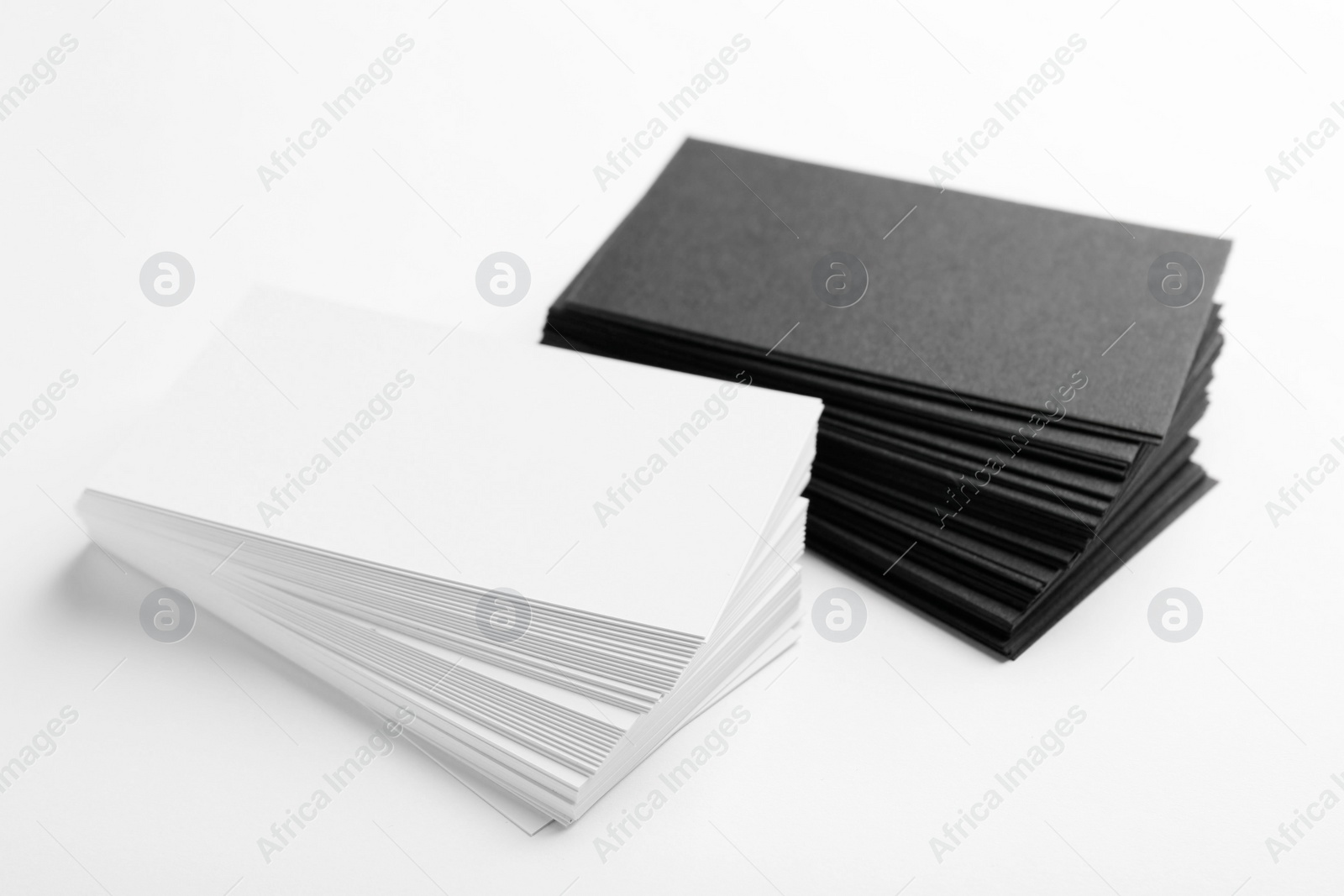 Photo of Many blank business cards on white background, closeup. Mockup for design