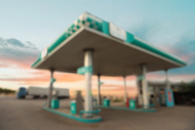 Image of Blurred view of modern gas filling station beside road