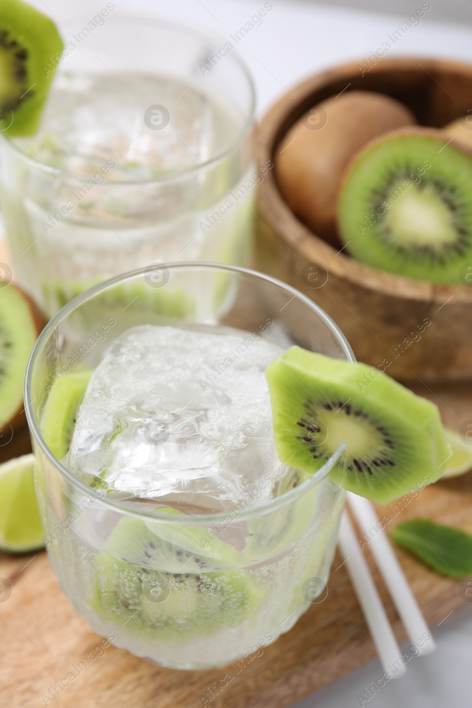 Photo of Refreshing drink with kiwi and ice on table