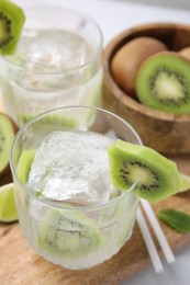 Photo of Refreshing drink with kiwi and ice on table