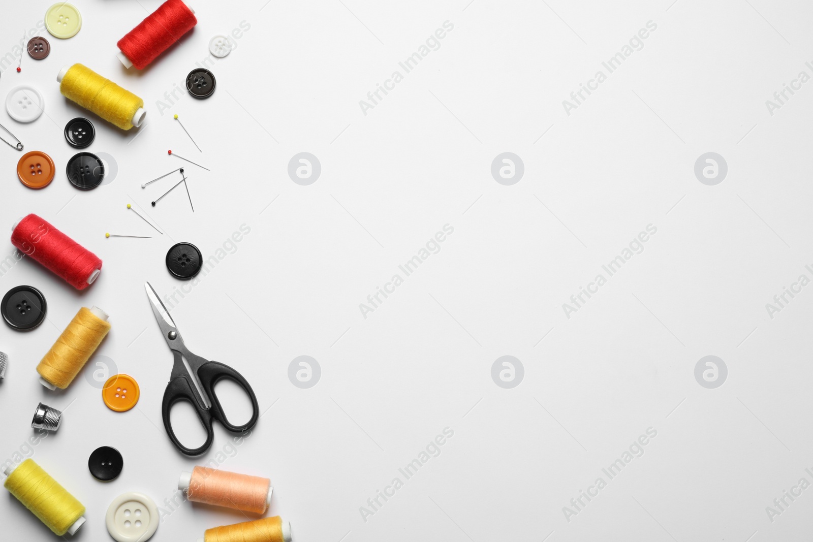 Photo of Composition with scissors and other sewing accessories on white background, top view