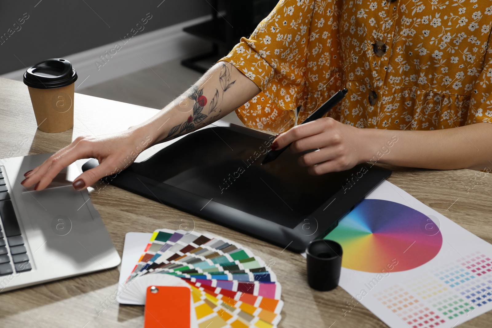 Photo of Professional designer with graphic tablet at wooden table, closeup