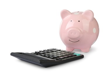 Photo of Piggy bank and calculator isolated on white