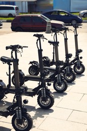 Many modern electric scooters on city street. Rental service