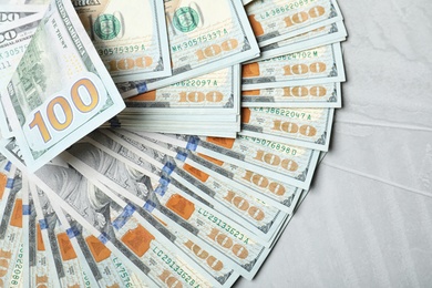 Photo of Many dollar banknotes on table, top view