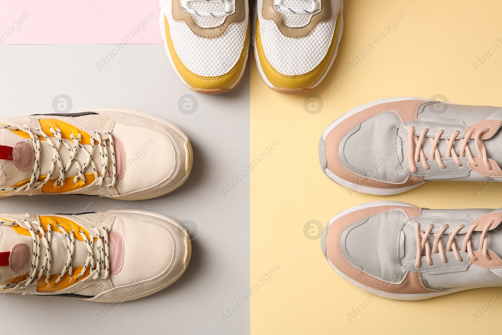 Photo of Different sports shoes on color background, top view