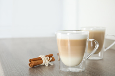 Delicious latte macchiato on wooden table indoors. Space for text