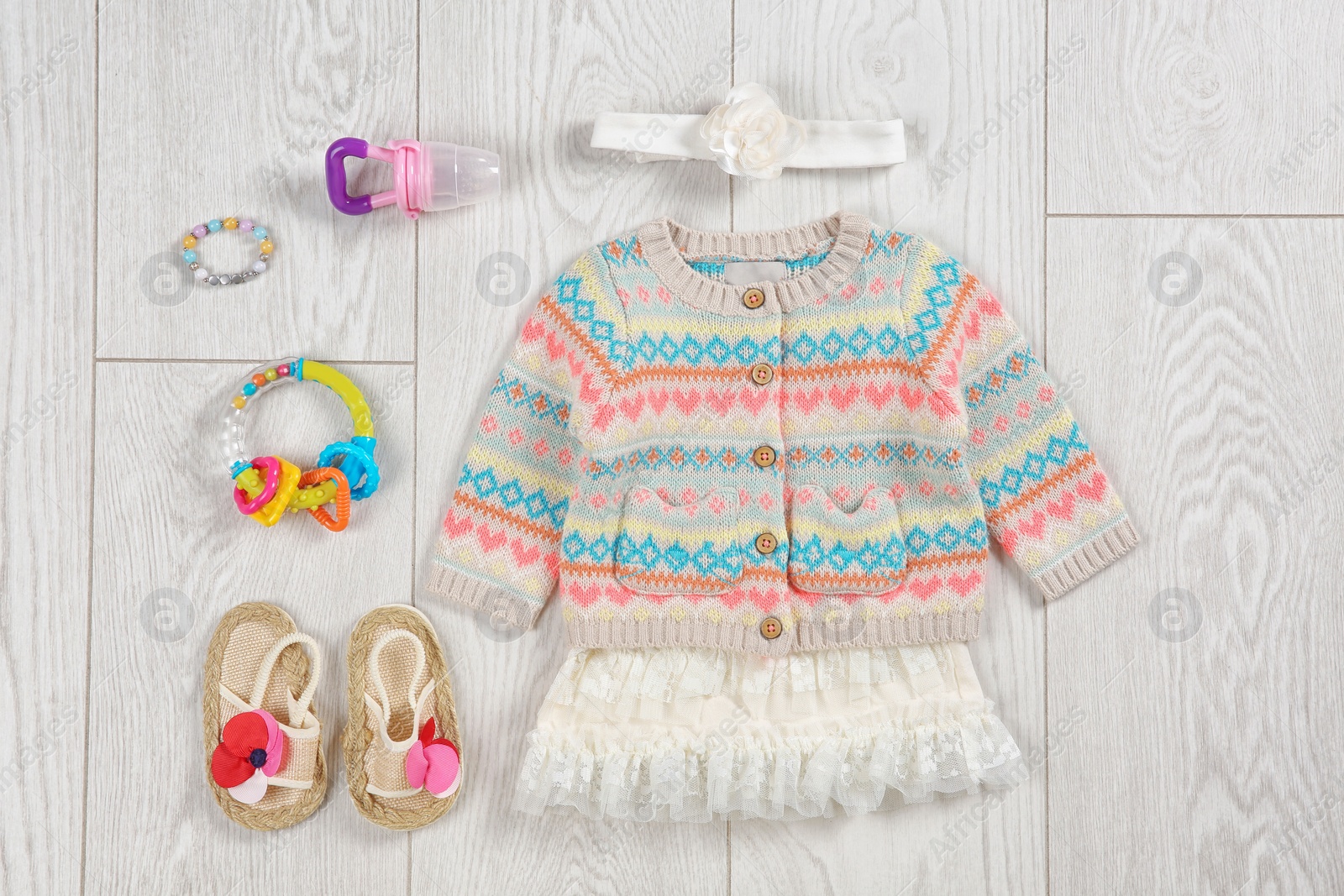 Photo of Flat lay composition with stylish child clothes and accessories on wooden background