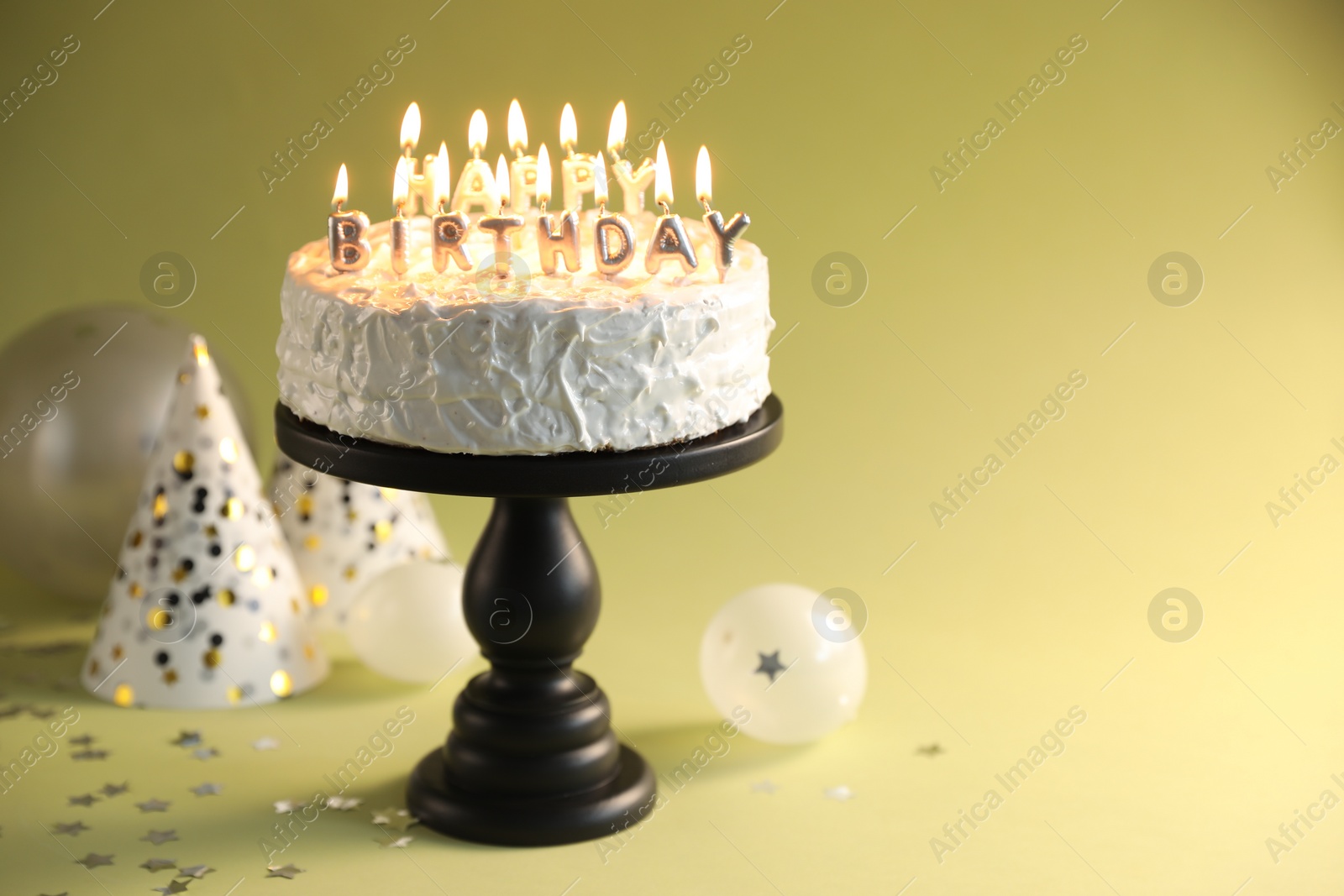 Photo of Tasty birthday cake with burning candles on green background, closeup. Space for text