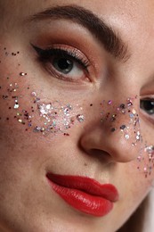 Beautiful woman with glitter freckles, closeup view