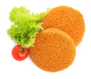 Photo of Uncooked breaded cutlets, tomato and lettuce on white background, top view. Freshly frozen semi-finished product