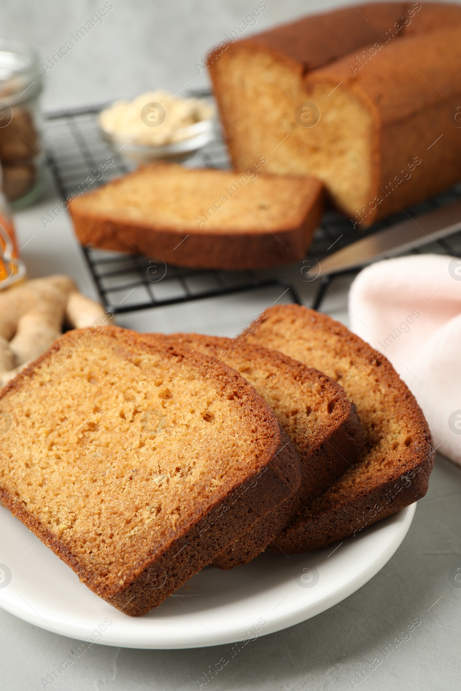 Photo of Fresh gingerbread cake slices served on light table, closeup