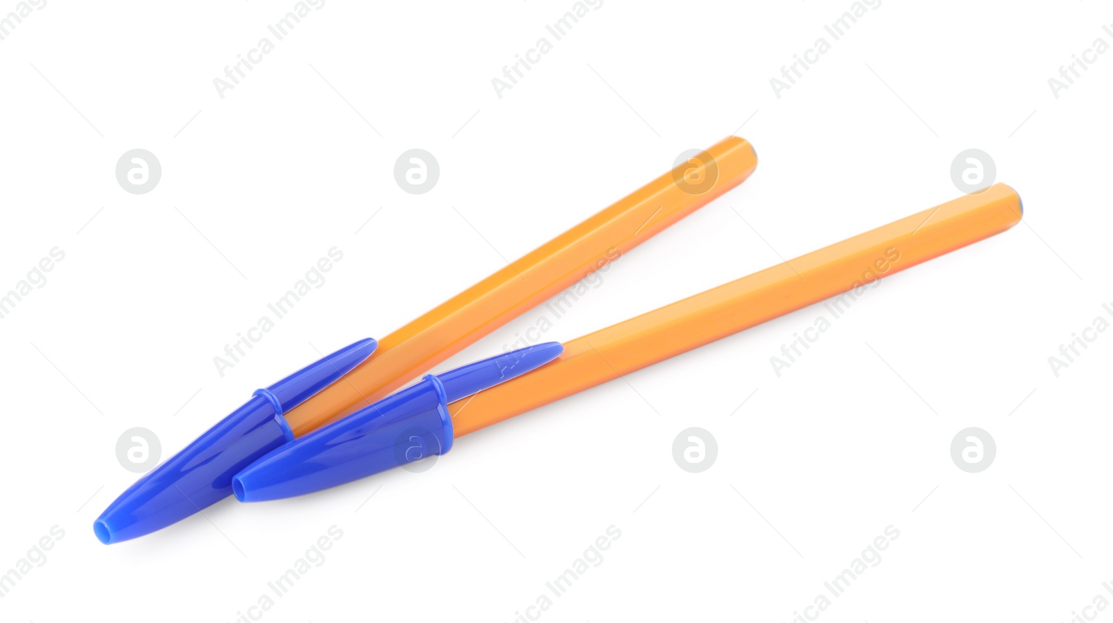 Photo of New orange plastic pens isolated on white