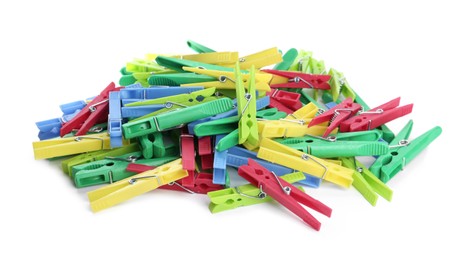 Many colorful plastic clothespins on white background