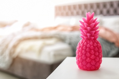 Pineapple shaped candle on table in room