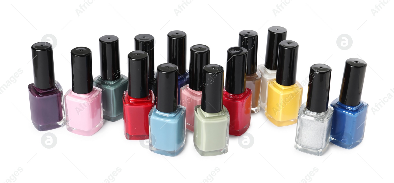 Photo of Bright nail polishes in bottles isolated on white