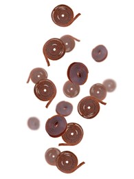 Image of Delicious fruit leather rolls falling on white background