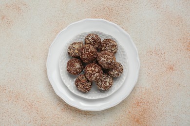 Photo of Delicious chocolate candies on beige table, top view