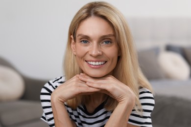 Photo of Portrait of beautiful woman with blonde hair. Attractive lady smiling and looking into camera