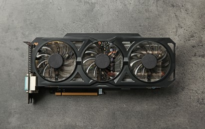 One computer graphics card on grey textured table, top view