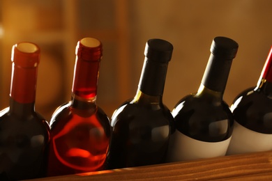 Photo of Bottles of different wines, closeup. Expensive collection