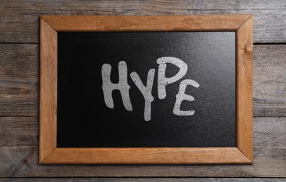 Image of Chalkboard with word Hype on wooden background